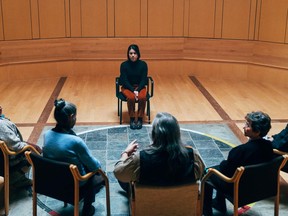 In this image from the movie Bootlegger, actress Devery Jacobs faces a council of elders.  The scene was shot at the Kitigan Zibi cultural center.