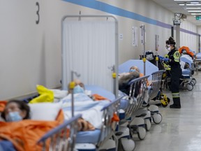 Patients wait in the hallway due to an at-capacity emergency room at the Humber River Hospital during the COVID-19 pandemic in January. This summer, ERs have been closing altogether.