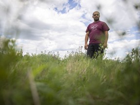 Josef Buttigieg, the owner of Fenek Farms stands for a portrait in his field at Fenek Farms where both grasshoppers and crickets have affected the farm's crops.