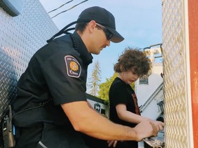 Firefighter McDougall from Station 94 provided Sam, a young man with auditory neuropathy spectrum disorder, a full truck tour using ASL sign language so he could receive the same experience as any other child who loves fire trucks. (Screen capture OFS via Twitter)