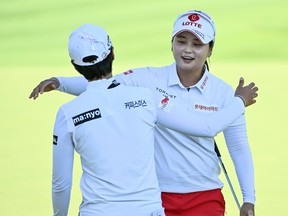South Korea's Hye-Jin Choi embraces fellow South Korean Narin An, left, after the 18th hole during the CP Women's Open in Ottawa, on Saturday, Aug. 27, 2022.
