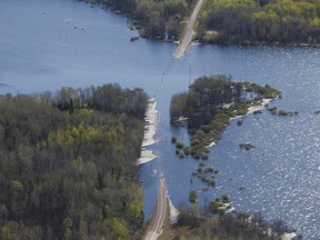 High water levels wash out highway 307 just northeast of Winnipeg, Tuesday, May 24, 2022. Floods, droughts and major storms that wash out highways, damage buildings and destroy power systems could cost Canada's economy $139 billion over the next 30 years, a new climate-based analysis predicts.