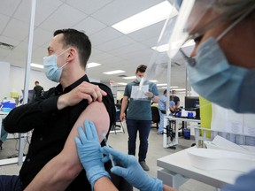A man is vaccinated for monkeypox at clinic run by public health authorities in Montreal, June 6, 2022.