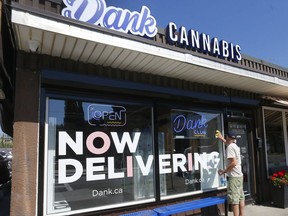 The windows at a Calgary cannabis store are cleaned on August 9, 2022 as the provine will no longer force licensed cannabis stores to black out their windows.
