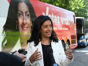 Quebec Liberal Leader Dominique Anglade responds to reporters questions by her campaign bus as she departs for the campaign trail, Sunday, August 28, 2022  in Quebec City.
