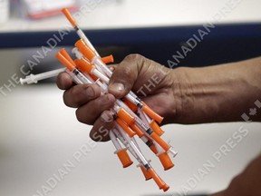Used needles are shown at a needle exchange in Miami, May 6, 2019. Despite pandemic slow-downs, Correctional Service Canada is still planning to expand the needle exchange programs currently offered at nine federal prisons, government officials say.