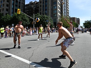 People pass around a volleyball during 2022 Capital Pride Parade in Ottawa on Sunday, Aug. 28, 2022.