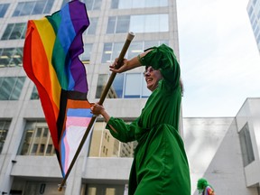 A person on stilts waves a Rainbow Flag during 2022 Capital Pride Parade in Ottawa on Sunday, Aug. 28, 2022.