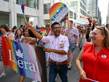 Liberal Member of Parliament for Ottawa-Center Yasir Naqvi engages with participants of the 2022 Capital Pride Parade in Ottawa on Sunday, Aug. 28, 2022.