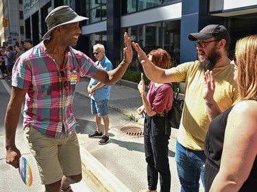 Parliamentary secretary to the prime minister and to the president of the Treasury Board Greg Fergus high fives participants of the 2022 Capital Pride Parade in Ottawa on Sunday, Aug. 28, 2022.