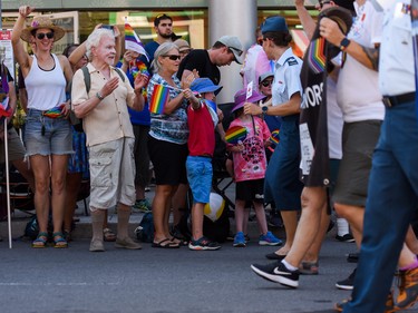 People watch as the 2022 Capital Pride Parade makes its way through the downtown core of Ottawa on Sunday, Aug. 28, 2022.