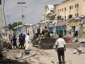 Police and military officials comb the scene of an al Qaeda-linked al Shabaab group militant attack, in Mogadishu, Somalia August 21, 2022.