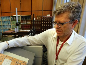 Files: Archivist Raymond Frogner handles the ledger in the archives room at the Royal BC Museum in VICTORIA, B.C. January  17, 2014.