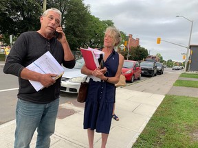 A bailiff named Dave, left, who declined to give his last name, arrives at St. Brigid’s church in Lowertown to serve legal papers on William Komer, a director of The United People of Canada organization, concerning an eviction hearing in an Ottawa court on Sept. 2. The landlord is trying to terminate TUPOC’s lease, which has led to a week-long standoff.