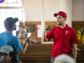 William Komer, right, a director of The United People of Canada, spoke with a counter-protester during Saturday’s media conference.