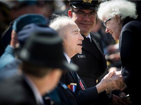 File photo: Veteran Alex Polowin is greeted by Elsa Lessard during the Battle of the Atlantic anniversary ceremony in May 2018 at the National War Memorial.