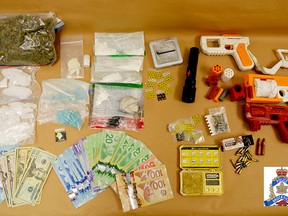 Brockville police released this image of drugs, weapons and cash seized in two raids on Thursday.