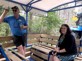 Hugh O'Neill, co-chairman of the International Plowing Match Tented City committee, gives a tour of the sprawling IPM site to North Grenville Mayor Nancy Peckford and others at a media conference Sunday.