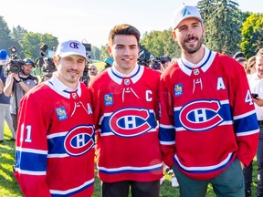 Nick Suzuki stops for a picture after being named new captain of the Montreal Canadiens with assistant captains Brendan Gallagher, left, and Joel Edmundson at the team's annual golf tournament in Laval, north of Montreal Sunday September 11, 2022.