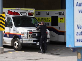 A paramedic works on a laptop on the hood of an ambulance, outside the Emergency Department at the Ottawa Hospital Civic Campus. We are a nation care-worn and ground down by a health-care system that isn’t working well.