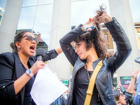 Maryam Fatahi stood in front of the crowd on a bench and cut off chunks of her curly hair to show support for Iranian women.