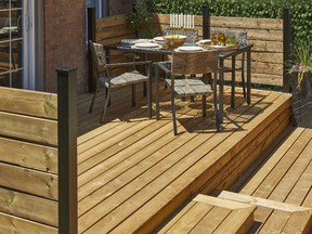 Designer Brenda Danso chose treated wood featuring a warm natural brown tone to protect the decks from the elements when transforming this Burlington backyard.