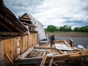 In this file photo from May, 2022, James Campbell, owner of Campbell Farms in White Lake, surveys damage to a barn, built in 1909, that was being used as a wedding and event venue.