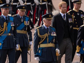 LONDON, ENGLAND - SEPTEMBER 14: (L-R) Prince William, Prince of Wales, King Charles III, Prince Harry, Duke of Sussex and Princess Anne, Princess Royal walk behind the coffin of Queen Elizabeth II as it is carried in a ceremonial procession from Buckingham Palace to the Palace of Westminster on September 14, 2022 in London.