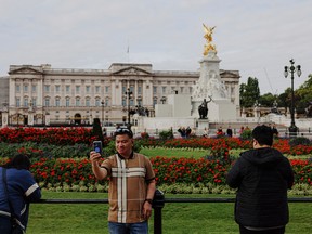 Tourists take photographs in front of Buckingham Palace on September 20, 2022 in London, England.