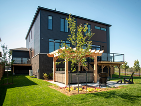 The backyard is oversized, with room for a hot tub and pergola, raised deck with glass railings so as not to impede the view, ground-level seating area and room to play. On the side, tucked behind the third garage, is the private guest suite balcony.