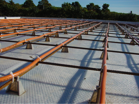 The orange pipes here carry hot water through what will become a finished floor after concrete is poured over everything and troweled smooth.