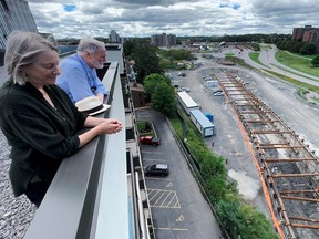 Katherine Addleman and Houston Eubank view Stage 2 LRT construction from atop their building at 1190 Richmond Road. Building residents are concerned about the noise and vibrations the new LRT line will create when it goes online.