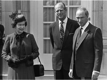 Queen Elizabeth II, Prince Philip and Prime Minister Pierre Trudeau pose for photographers at 24 Sussex, residence of the PM in Ottawa, Ont. April 16, 1982. The Queen is in Ottawa on a four-day visit and to take part in an historic ceremony April 17 to proclaim the 115-year-old nation's new constitution and sever Canada's last colonial bond with England.