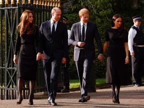 William, Prince of Wales, Catherine, Princess of Wales, Prince Harry and Meghan, the Duchess of Sussex, walk outside Windsor Castle, following the passing of Britain's Queen Elizabeth, in Windsor, Britain, September 10, 2022.