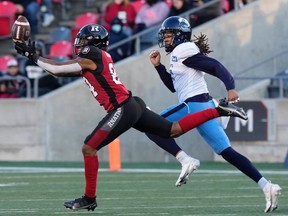 Ottawa Redblacks wide receiver R.J. Harris, left, tries to pull in a long pass under pressure from Toronto Argonauts defensive back Jalen Collins during first half CFL action, Saturday, November 6, 2021 in Ottawa.