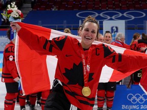 Files: Marie-Philip Poulin of Canada celebrates with her gold medal during the Beijing Olympics medal ceremony.