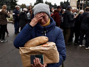 Nina Shevchenko, 65, reacts after she received humanitarian aid, as Russia's attack on Ukraine continues, in the recently liberated town of Izium, in Kharkiv region, Ukraine September 27, 2022.