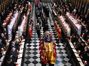 The family of Queen Elizabeth walks behind the coffin as they leave Westminster Abbey in London on September 19, 2022.