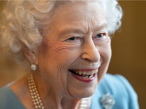 In this file photo taken on Feb. 5, 2022, Queen Elizabeth II smiles during a reception in the ballroom of Sandringham House. Her smile, seen in person, is never forgotten.