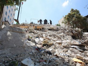 Jordanian rescue teams search for 10 people still missing under the rubble of a collapsed four-storey building in the capital Amman on September 14, 2022, a day after 5 bodies were recovered there.