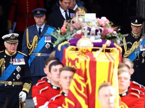 Britain's King Charles III, William, Prince of Wales, and Prince Edward walk as the coffin of Britain's Queen Elizabeth is carried out of Westminster Abbey after a service on the day of her state funeral and burial, in London, Britain, September 19, 2022.