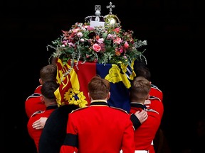 The Bearer Party take the coffin of Queen Elizabeth II, from the State Hearse, into St George's Chapel inside Windsor Castle on September 19, 2022, for the Committal Service for Britain's Queen Elizabeth II.