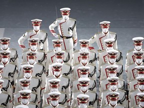 TOPSHOT - Uniformed personnel walk in during the state funeral of former Japanese prime minister Shinzo Abe at the Nippon Budokan in Tokyo on September 27, 2022.