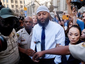 Adnan Syed, whose case was chronicled in the hit podcast Serial, departs the courthouse with his attorney Erica Suter, after a judge overturned Syed's 2000 murder conviction and ordered a new trial during a hearing at the Baltimore City Circuit Courthouse in Baltimore, Maryland U.S., September 19, 2022.