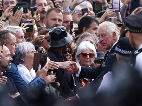 Britain's King Charles meets with members of the public outside Buckingham Palace, following the passing of Britain's Queen Elizabeth, in London, Britain, September 9, 2022. REUTERS/Henry Nicholls