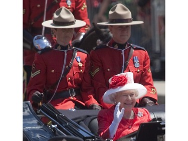 Queen Elizabeth waves as she arrives for Canada Day celebrations on Parliament Hill in Ottawa on Canada Day Thursday, July 1, 2010.