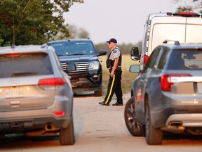 A Royal Canadian Mounted Police (RCMP) officer arrives at a crime scene after multiple people were killed and injured in a stabbing spree in Weldon, Saskatchewan, Canada. September 4, 2022.