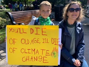 Louka Kavcic, 11, and his mom Laurie-Anne Muldoon attended the climate strike rally at Confederation Park on Friday. Jacquie Miller/Postmedia
