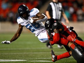 Toronto Argonauts wide receiver Damonte Coxie (86) is tackled by Ottawa Redblacks linebacker Frankie Griffin (28) during CFL football action in Ottawa on Sept. 24.