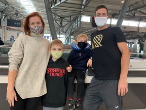 From left, mom Lauren Elliott, kids Tavish, 9, Kian, 6, and dad Marcus Kaulback were at the Ottawa airport, waiting for a flight to Vietnam for a family vacation.